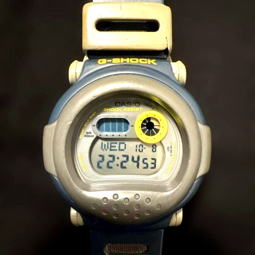 Casio G-Shock G-001 Jason Revival Edition digital watch in gray and blue with visible wear and broken band loop