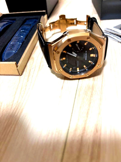 Casio G-Shock GA-2100 digital watch with rose gold and black face and black leather band