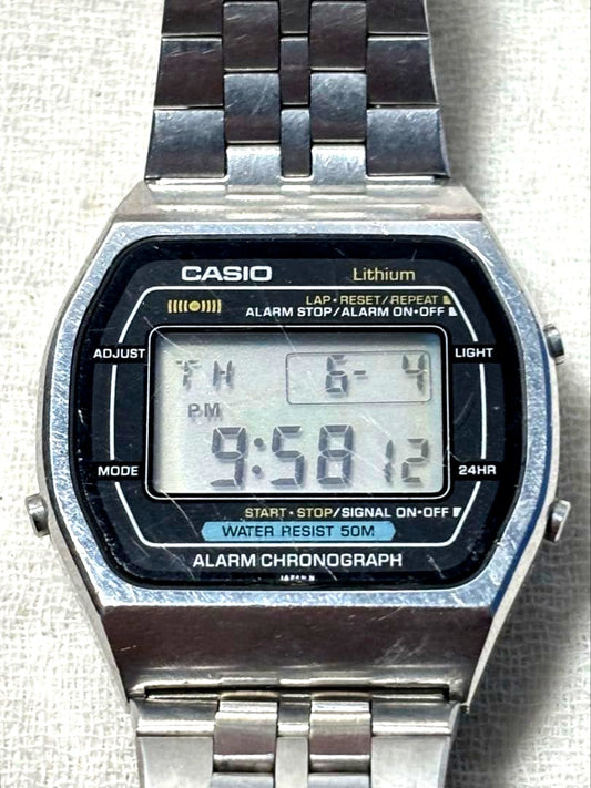 Casio W-51 series watch with visible scratches on glass and backlight feature in current condition