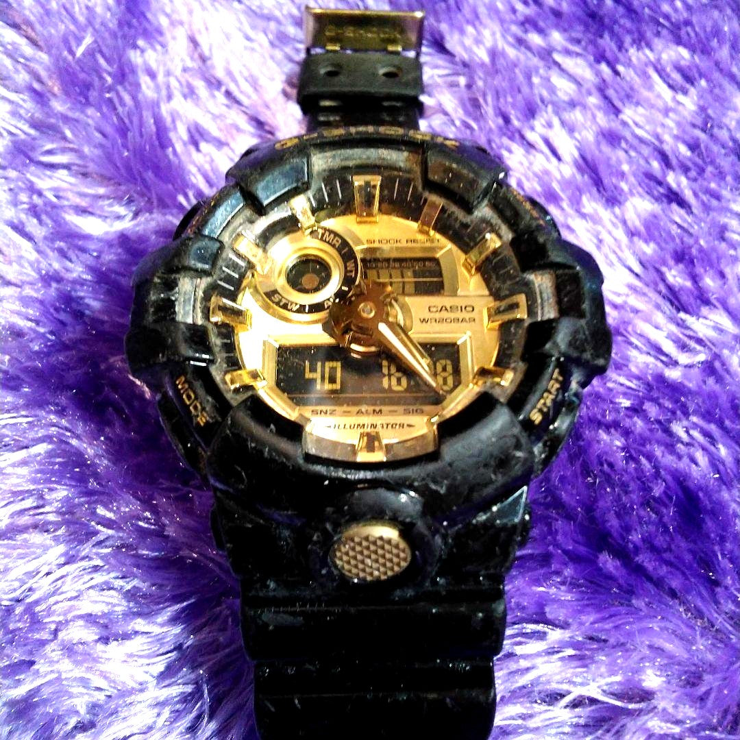 Used Casio G-Shock GA-710GB black and gold quartz watch with visible scratches and signs of wear