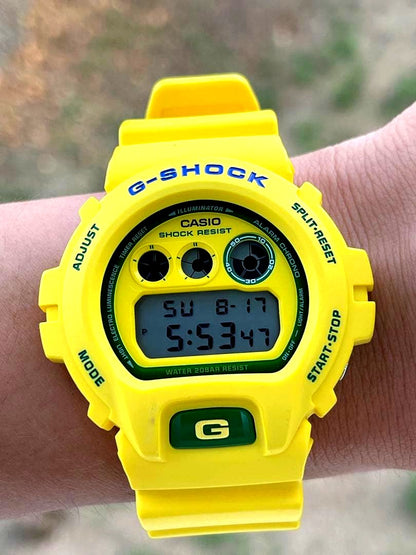 Casio G-Shock yellow wristwatch with digital display and 200m water resistance