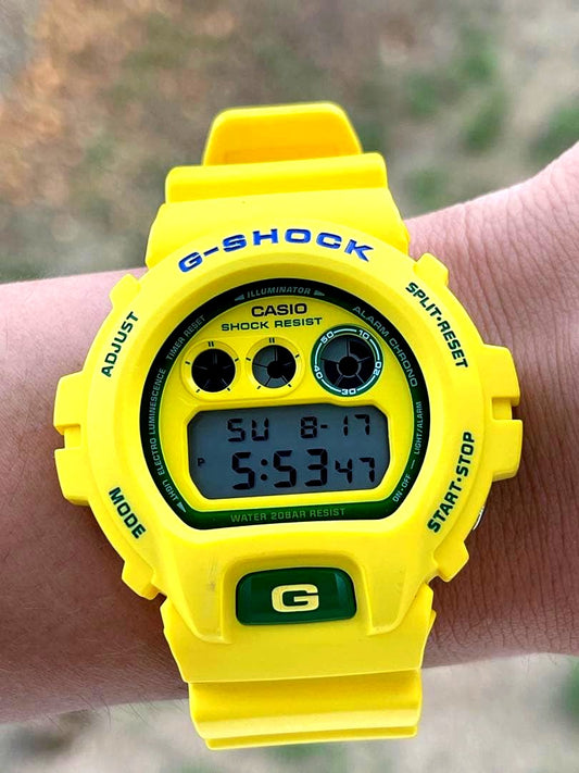 Casio G-Shock yellow wristwatch with digital display and 200m water resistance
