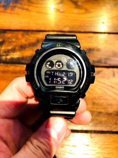 Casio G-Shock black digital watch with round case and black plastic band