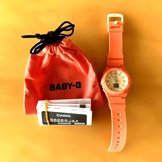 Casio Baby-G pink watch with day and date display on a white background