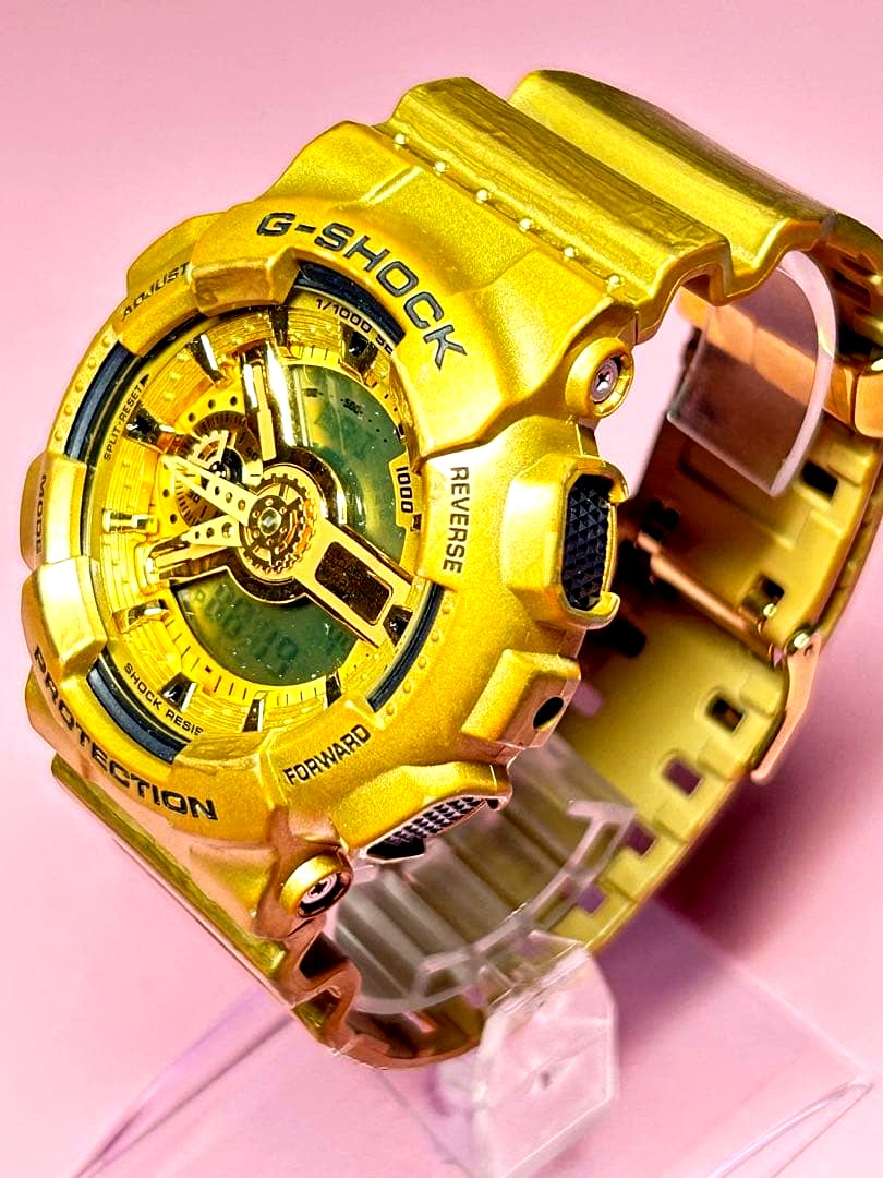 Casio G-Shock GA-110GD gold analog-digital wristwatch showing battery replacement status and worn strap
