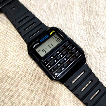 Front view of used Casio CA-53W digital wristwatch with visible signs of wear