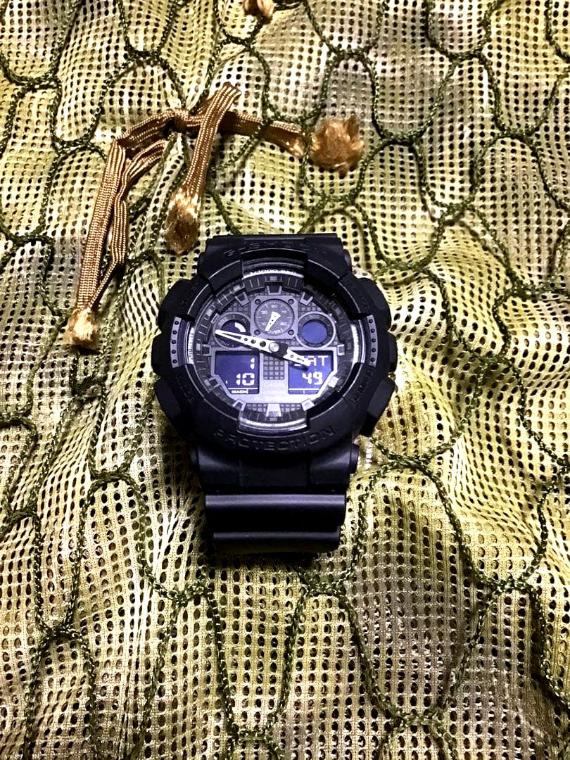 Casio G-Shock GA-100 military wristwatch in black with rubber band and digital display