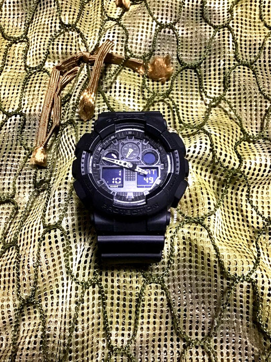 Casio G-Shock GA-100 military wristwatch in black with rubber band and digital display