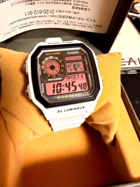 White Casio AE-1200WH digital watch with dual time display and EL backlight
