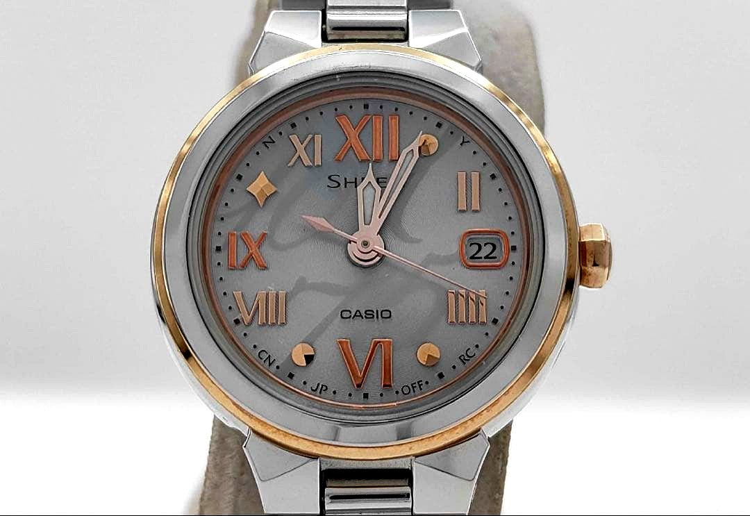 Casio Sheen women's solar watch SHW-1508 with silver dial, pink gold accents, date display, and Roman numeral markers