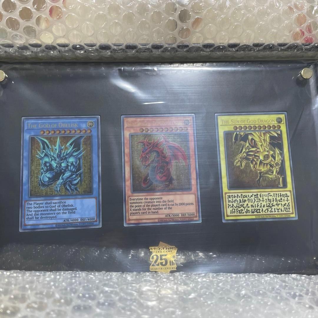 Yugioh The Three Sacred Gods stainless steel special card set with three cards, acrylic display case, metal feet, and instructions