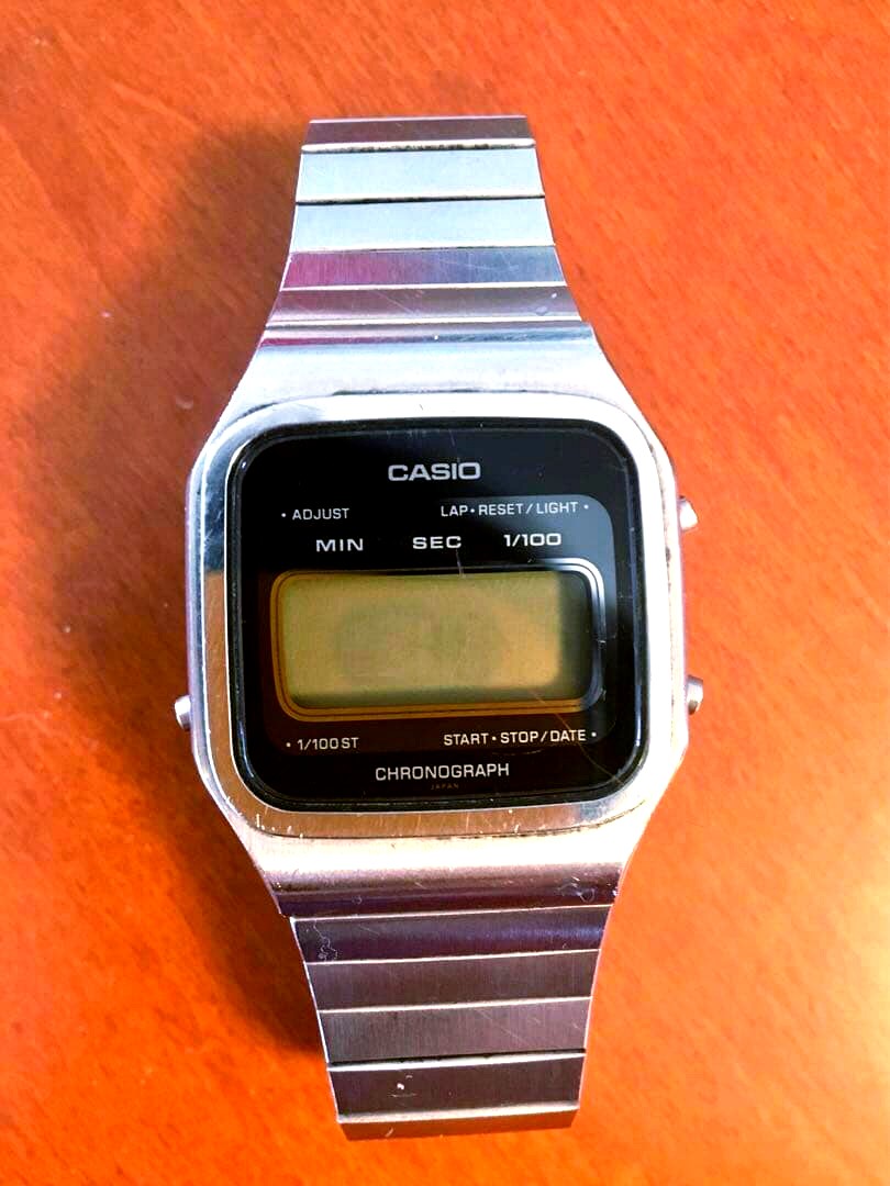 Casio Chronograph digital watch with stainless steel band showing digital display and stainless steel strap