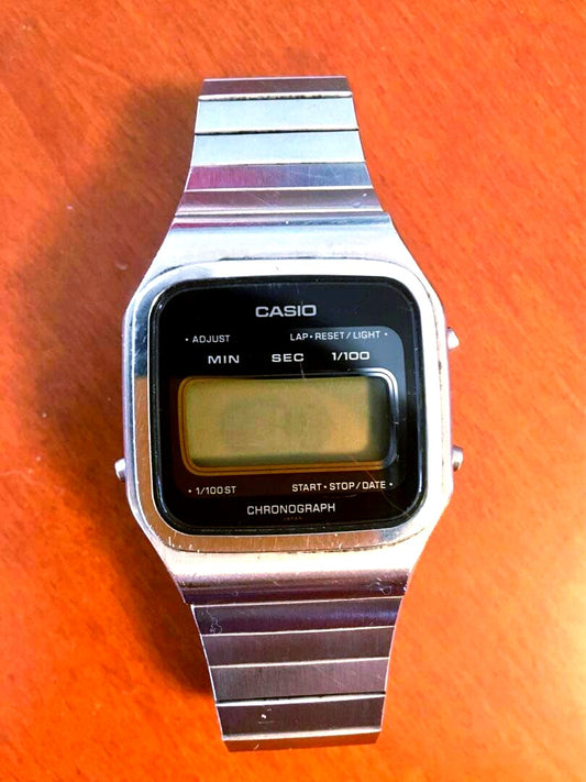 Casio Chronograph digital watch with stainless steel band showing digital display and stainless steel strap