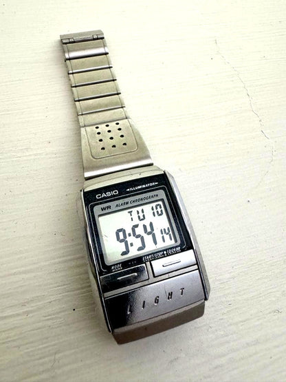 Casio digital watch with silver stainless steel band and digital display showing alarm and chronograph features