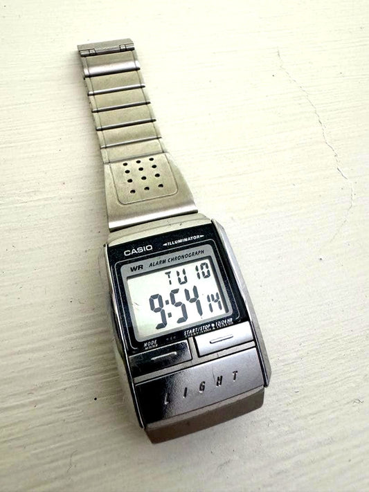 Casio digital watch with silver stainless steel band and digital display showing alarm and chronograph features