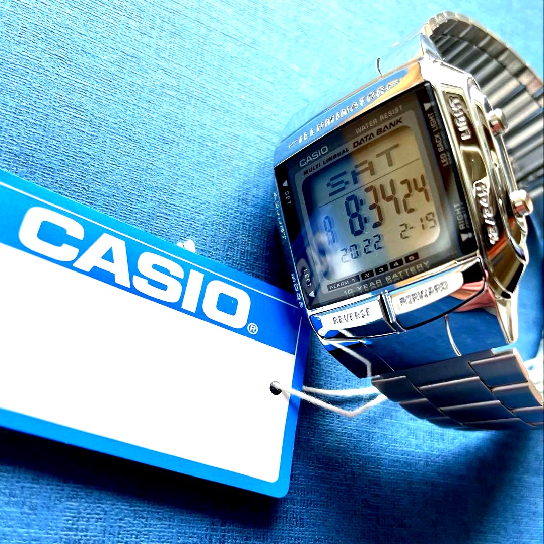 Casio Digital Watch QX81602 with silver case, stainless steel band, and 13-language data bank feature