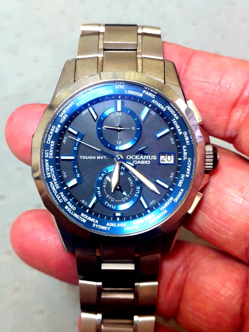 Used Casio Oceanus OCW-S2000 wristwatch with blue dial and metal band, shown on white background
