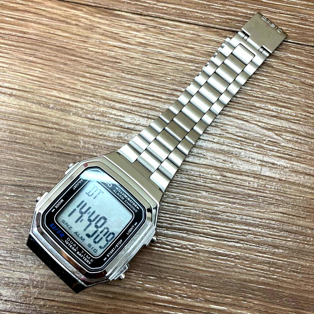 Casio A178W digital watch with silver metallic finish and square display showing time and date