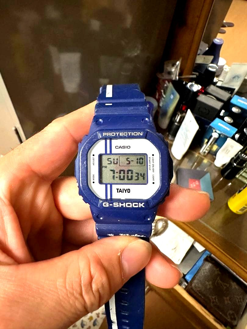Casio G-Shock DW-5600 digital watch in blue with TAIYO marking and scratch signs