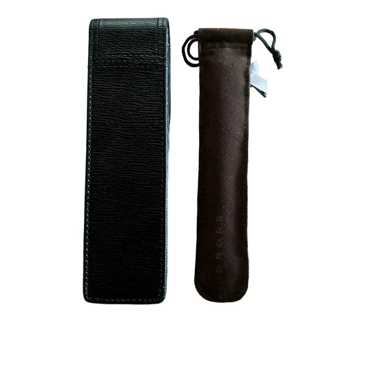 CROSS white ballpoint pen alongside a leather pen case with heart charm