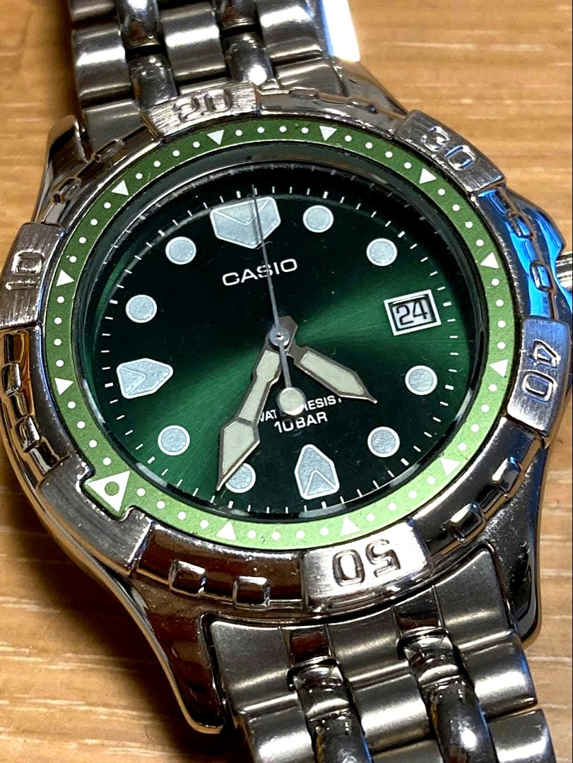 Casio quartz wristwatch with green dial stainless steel case and date display