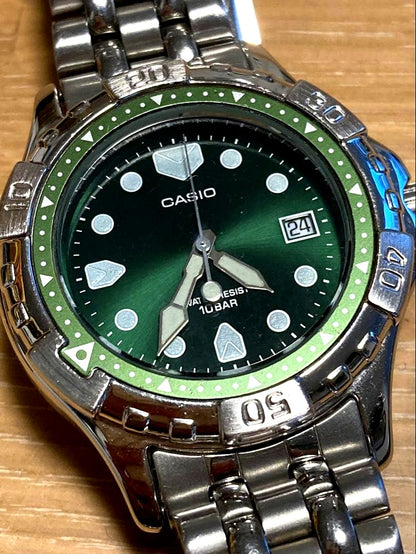 Casio quartz wristwatch with green dial stainless steel case and date display