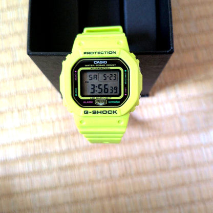Casio G-Shock digital watch with neon yellow body and LED backlight, water resistant to 20 ATM