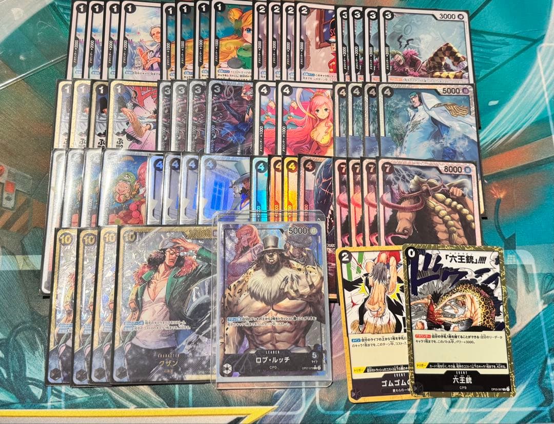 Luchi One Piece Card Deck Construction Set with black sleeves, playmat, storage box, and event parts