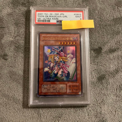 Ultra Rare Toon Dark Magician Girl Yu-Gi-Oh! trading card graded PSA 9 with Japanese text