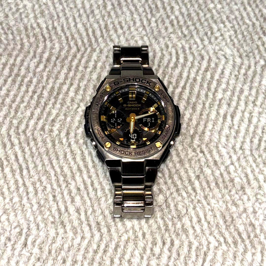 Casio G-Shock GST-W110D solar watch showing the main body and stainless steel band with minor signs of use
