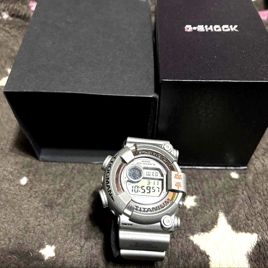 Casio G-Shock Frogman DW-8201 silver and gray watch showing frog figure backlight feature