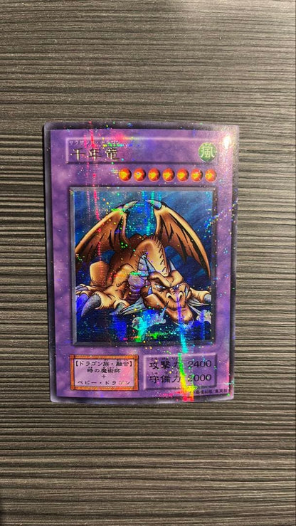 Initial edition Yugioh Millennium Dragon card from Japan with surface scratches and slight corner bend in used condition
