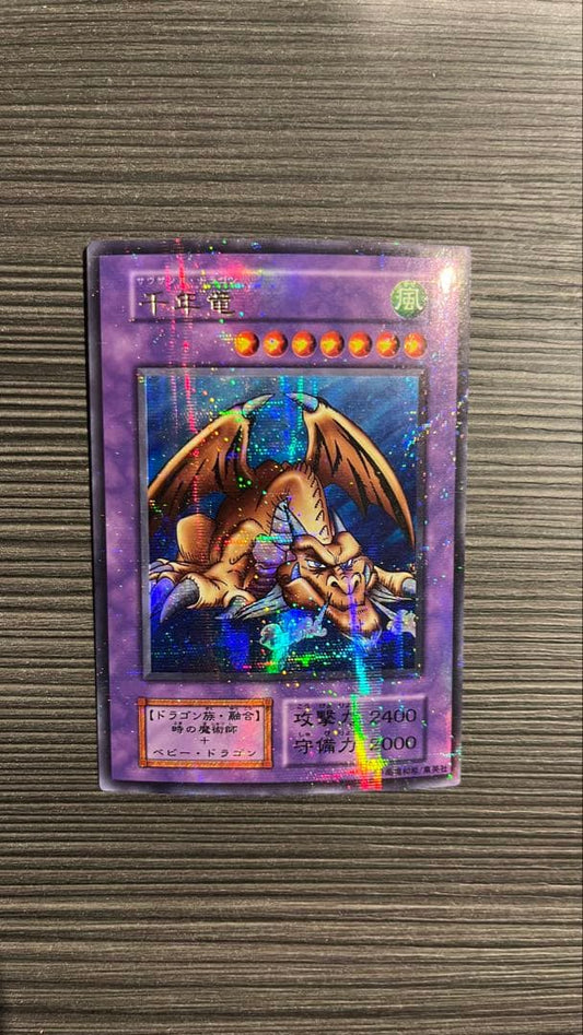 Initial edition Yugioh Millennium Dragon card from Japan with surface scratches and slight corner bend in used condition
