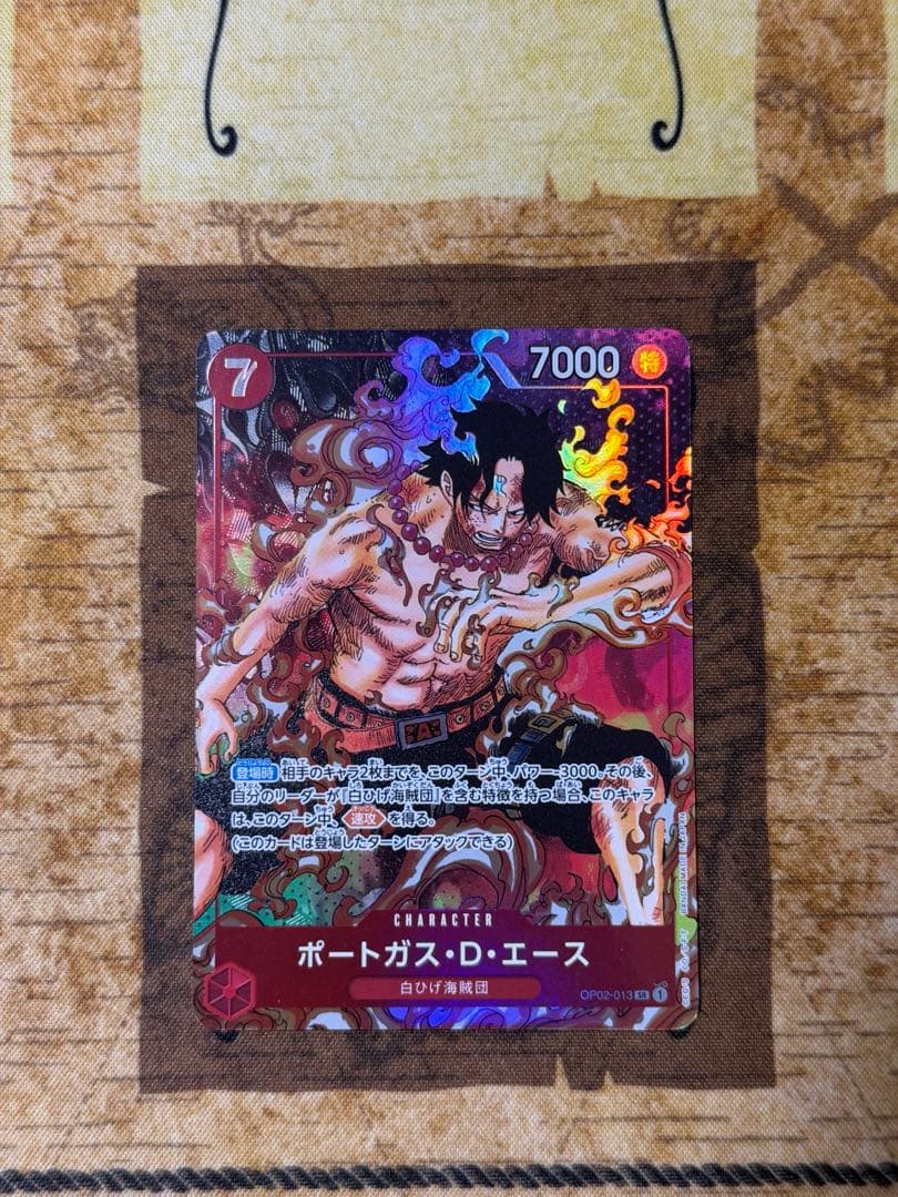 One Piece Ace Parallel collectible card with vibrant artwork of Ace character
