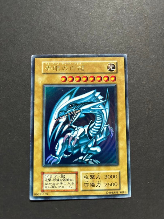 Blue-Eyes White Dragon Ultra Rare Yu-Gi-Oh! OCG card from starter box with visible wear