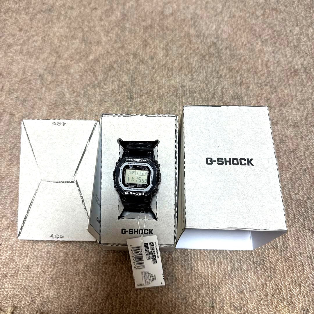Casio G-Shock DW-5600RGM-1JR watch with origami design, black digital display, and rugged shock-resistant case