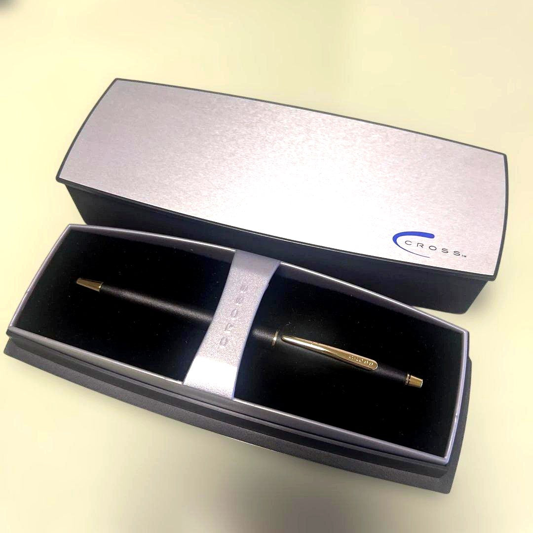 Cross ballpoint pen with matte black body and gold clip displayed with dedicated case