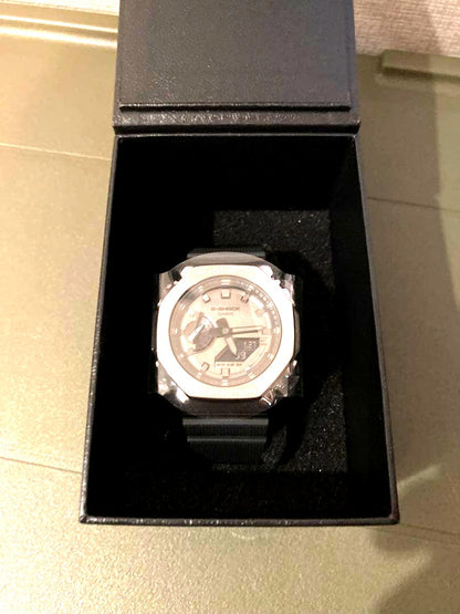 Casio G-Shock GM-2100-1JF watch with metal bezel, resin strap, black dial, and shock resistant design