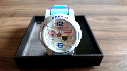 Casio Baby-G BGA-180 watch with gray dial and green strap, showing the front view