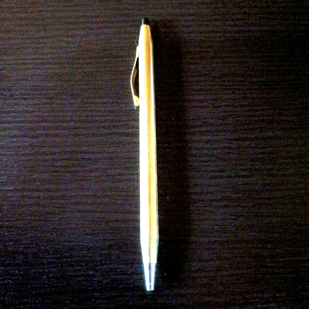 Cross brand gold color twist-operated ballpoint pen with slim sleek design