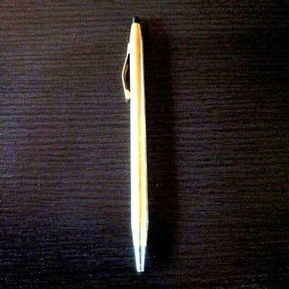 Cross brand gold color twist-operated ballpoint pen with slim sleek design