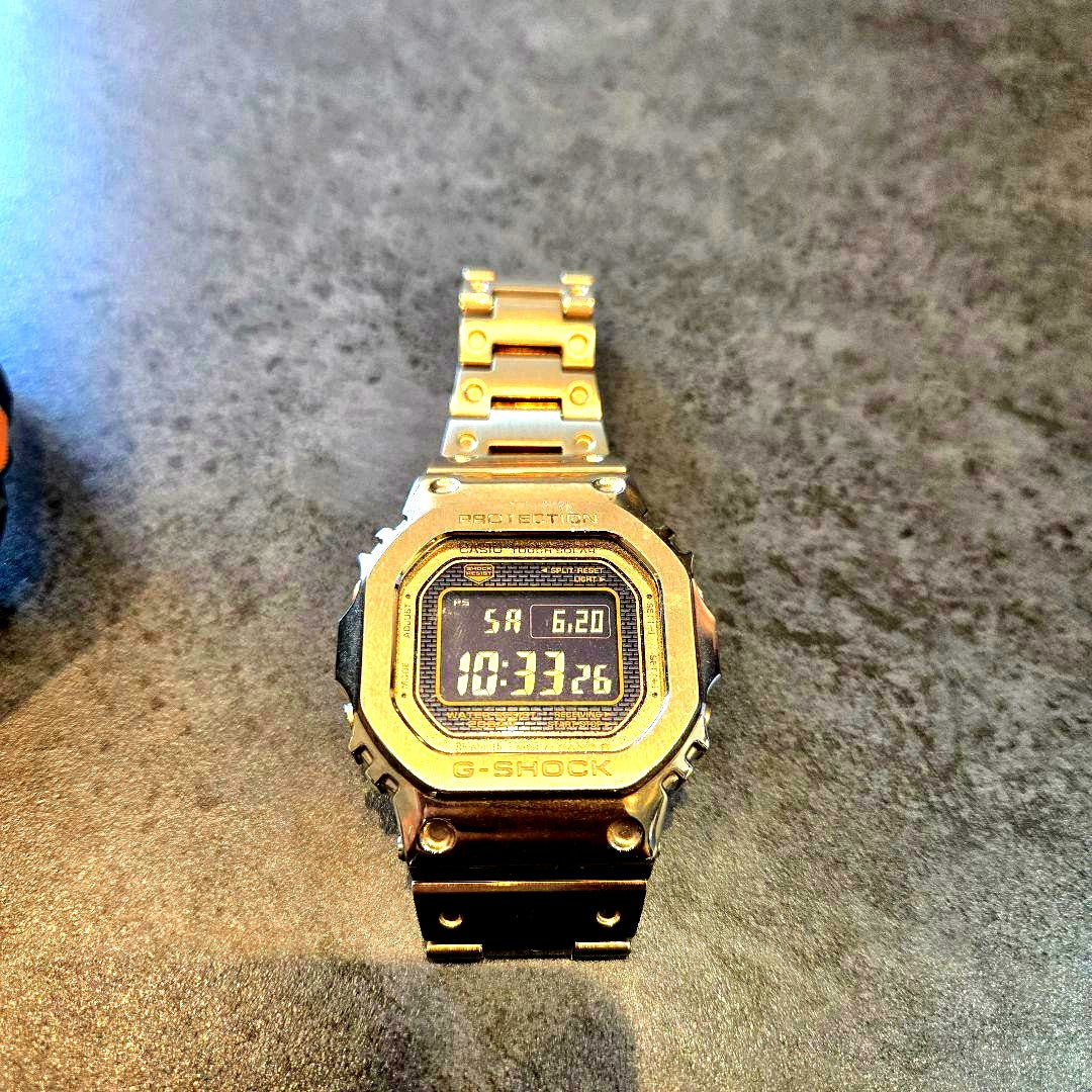 Casio G-Shock GMW-B5000 gold metal digital watch with full stainless steel case and bracelet