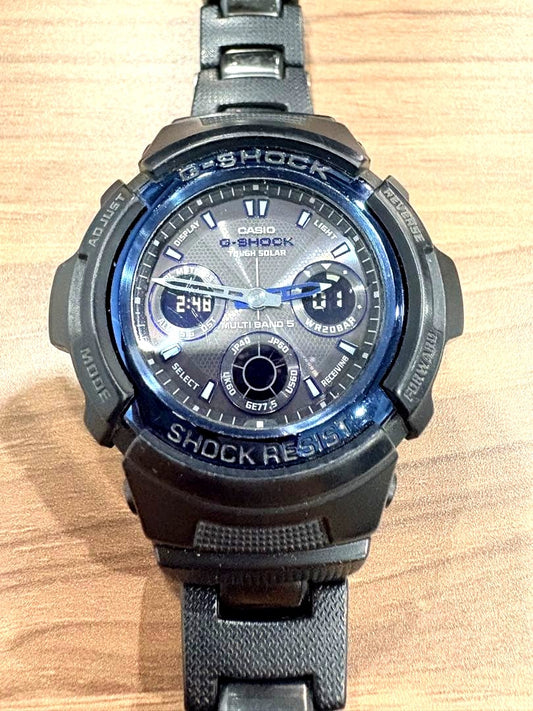 Casio G-Shock AWG-100BC watch with black body, blue bezel, and metal core band