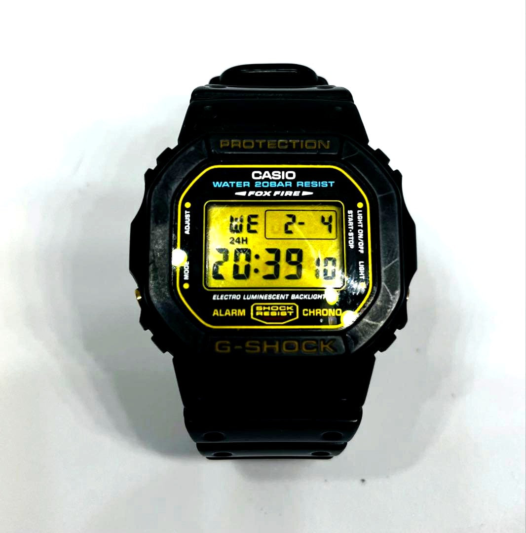 Casio G-SHOCK DW-5600E Vintage Model 1545 wristwatch with gold buckle and buttons, used condition