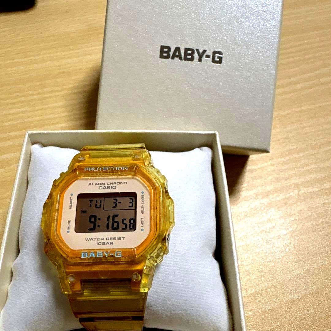 Baby-G Casio digital watch with yellow plastic band and 10BAR water resistance shown on white background