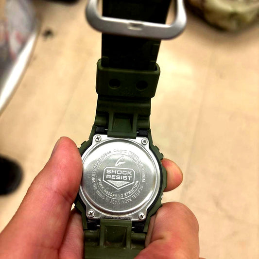 Casio G-Shock DW-5600M digital watch in khaki color with shock resistant and water resistant features