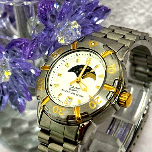 Casio LD-716 Moon Phase wristwatch with silver case, black strap, and moon phase feature