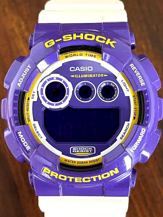 Casio G-SHOCK GD-1200S purple and white watch with visible scratches on the used casing