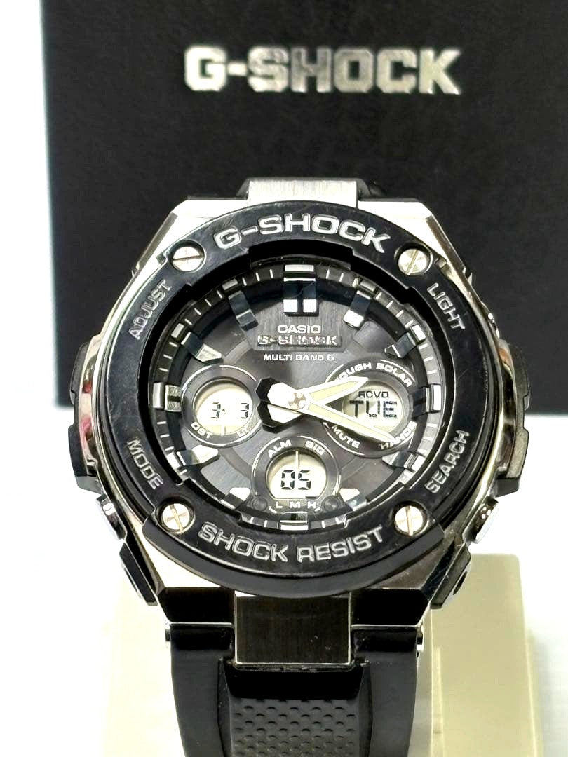 Casio G-Shock GST-W300G-1AJF watch with resin bezel and stainless steel case, displayed with box and manual