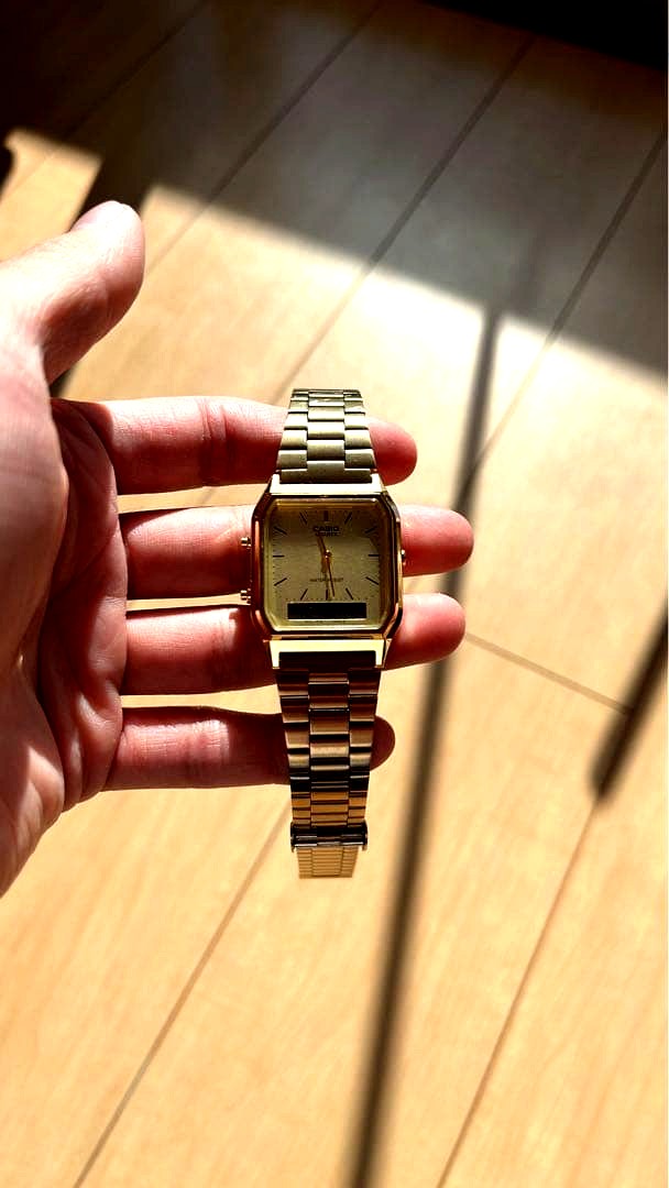Casio digital square watch with gold metal band and steel back, featuring a digital display and square steel case